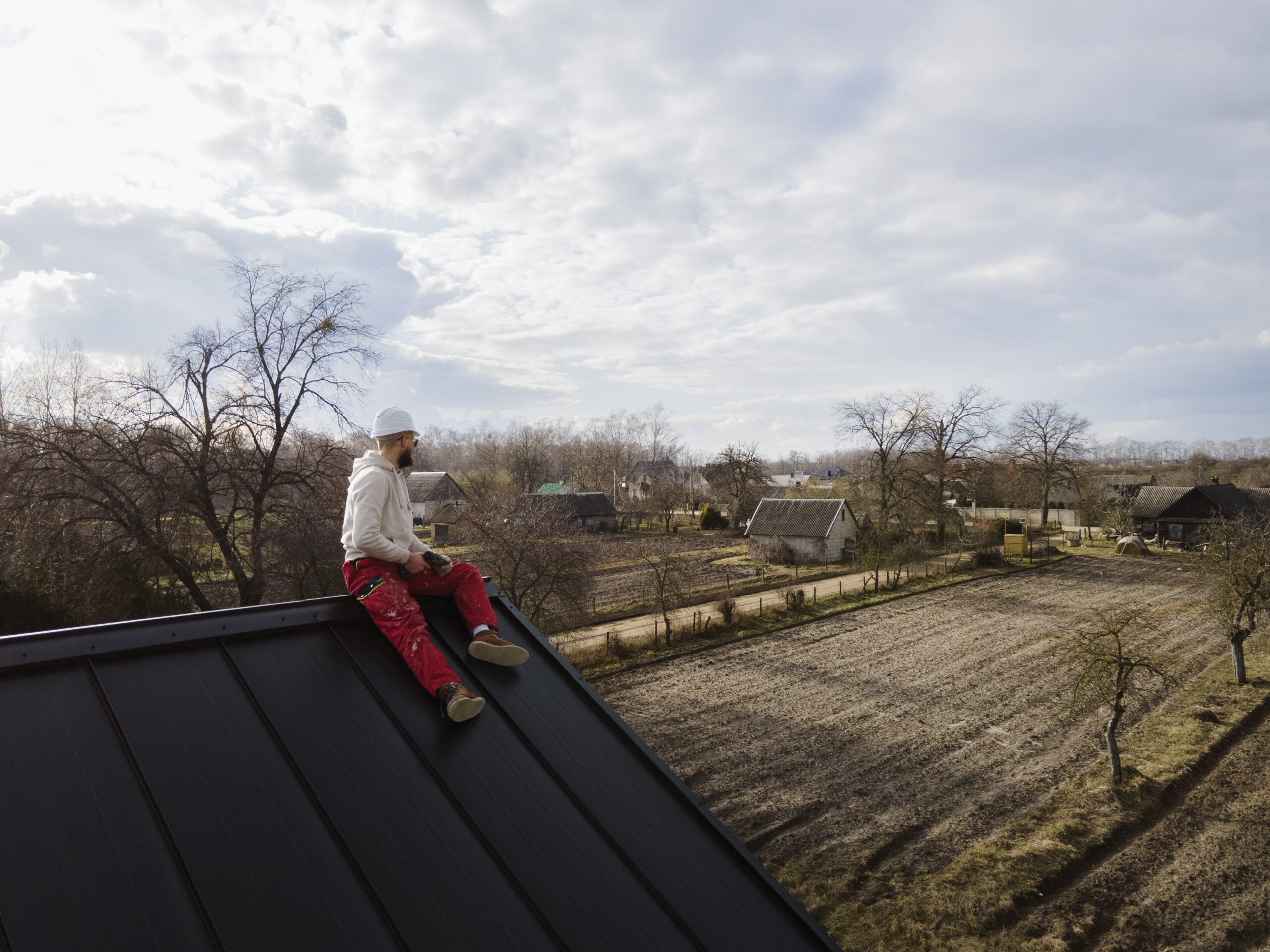 St. Petersburg FL roofing contractor examining rooftop after installation